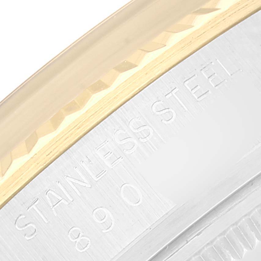 This close-up image shows the "STAINLESS STEEL" engraving and part of the bezel of a Rolex Datejust 16013 Men's Steel and Gold (two tone) Champagne Dial 16013 Men's Steel and Gold (two tone) Champagne Dial watch.