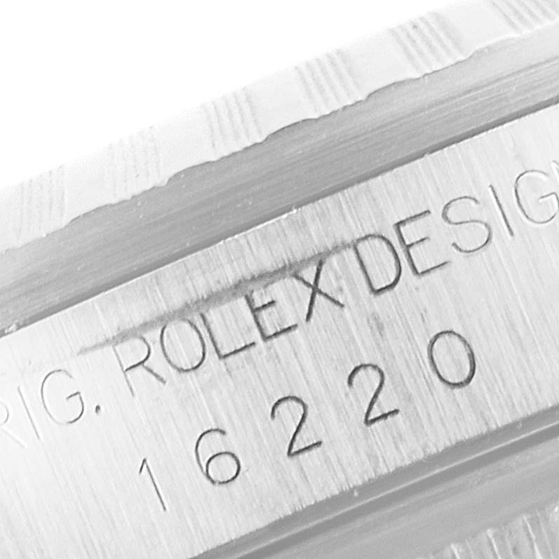 This image shows an engraved serial number and design details on the side of a Rolex Datejust 16220 Men's Stainless Steel White Dial 16220 Men's Stainless Steel White Dial watch.