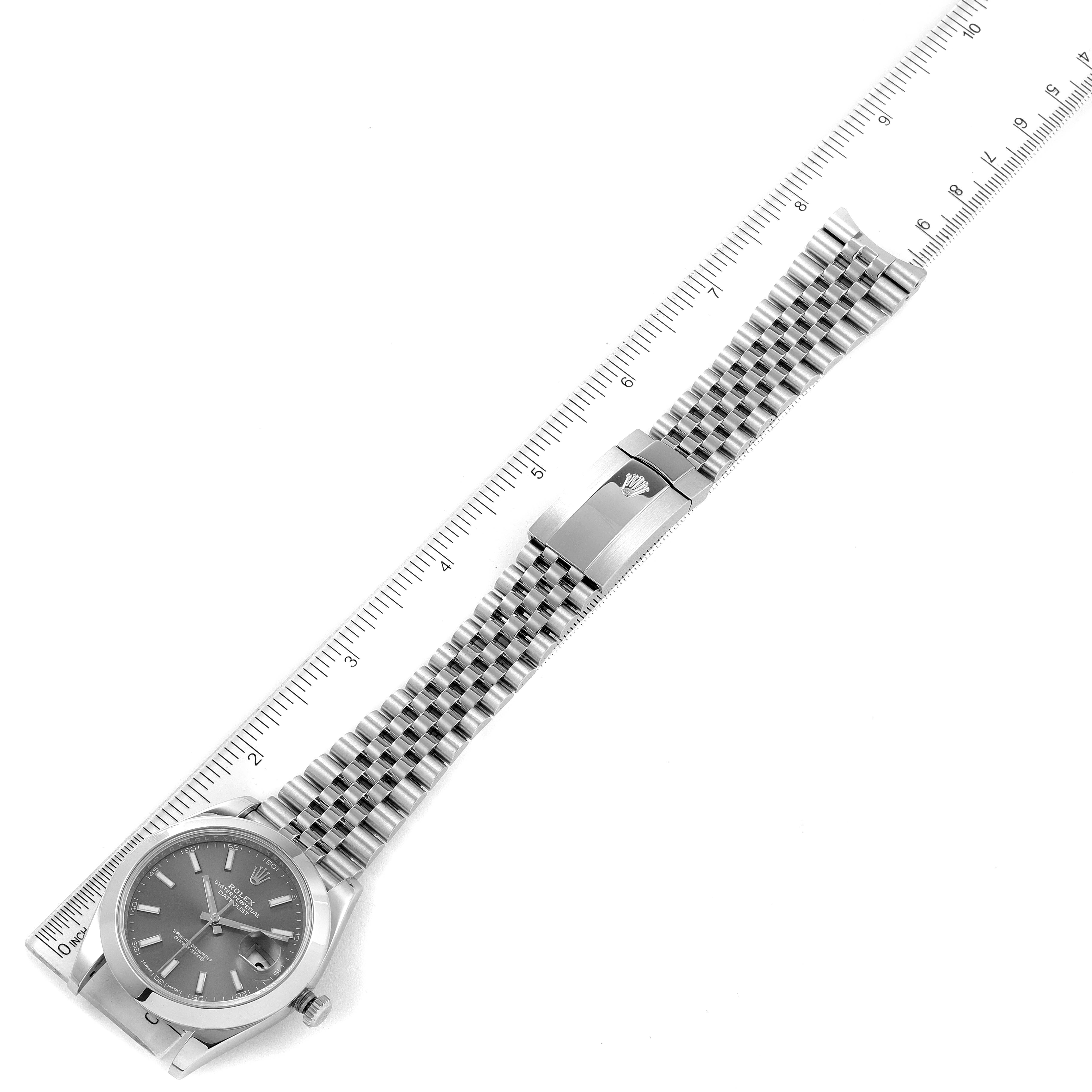 The Rolex Datejust 41 126300 Men's Stainless Steel Grey Dial 126300 Men's Stainless Steel Grey Dial watch is shown laid flat with its metal bracelet and clasp visible along a measuring ruler.