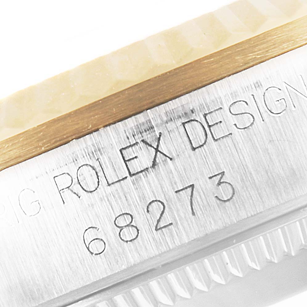 This image shows a close-up of the case side and bezel of a Rolex Mid-Size 68273 Women's Steel and Gold (two tone) Grey Dial 68273 Women's Steel and Gold (two tone) Grey Dial model with the design number 68273 engraved.