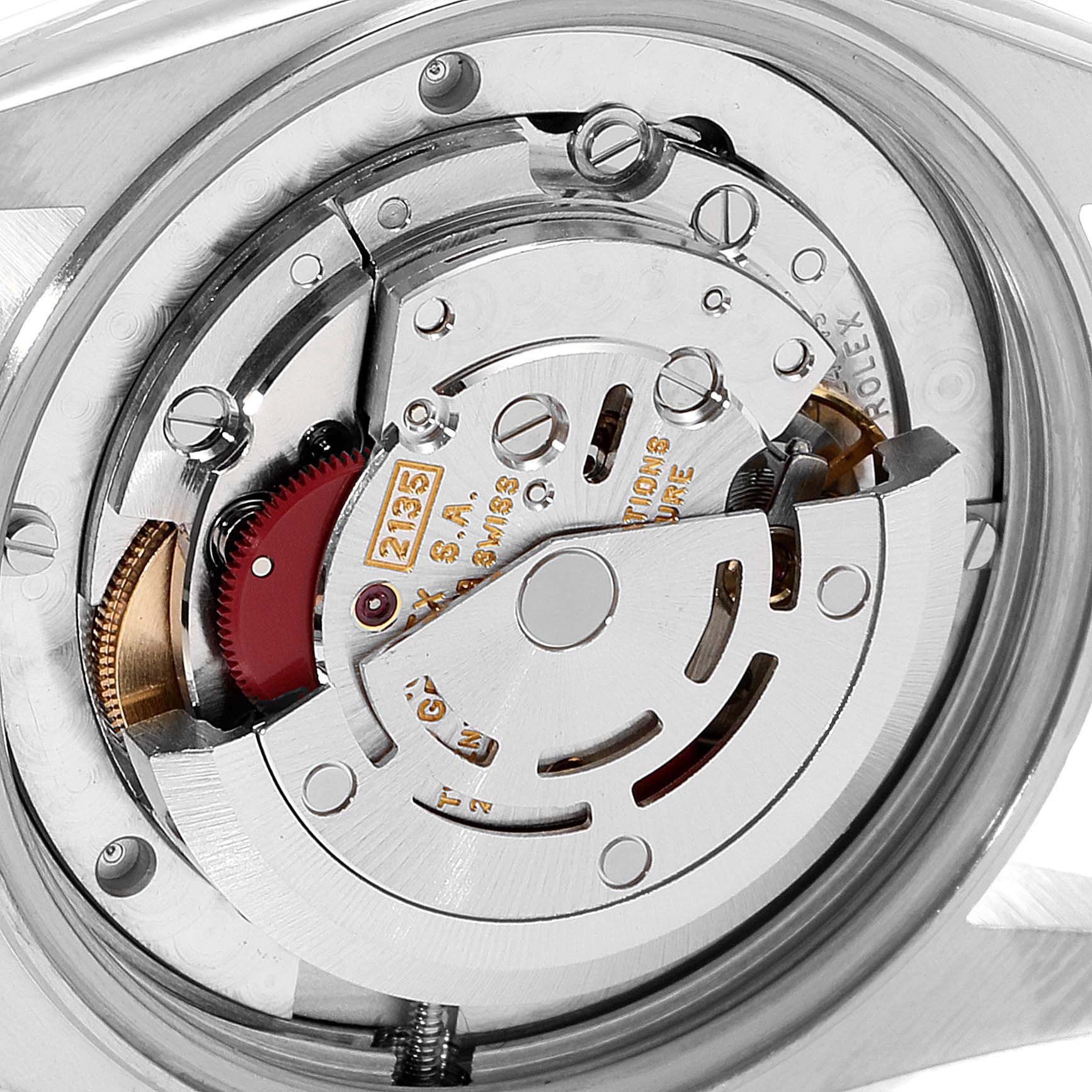 The image shows a close-up view of the movement inside a Mid-Size Rolex watch.