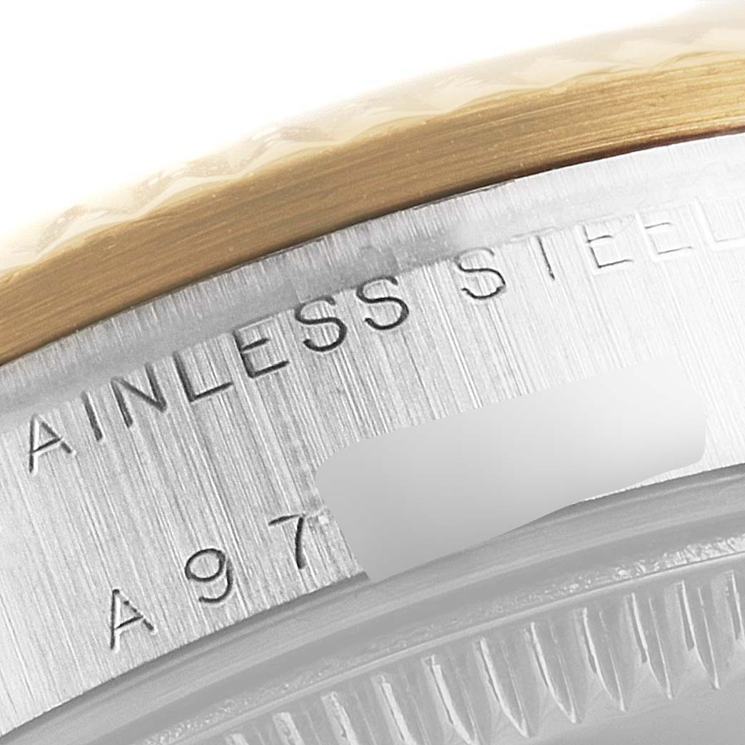 The image shows a close-up of the side of a Rolex Mid-Size 78273 Women
s Steel and Gold (two tone) Grey Dial 78273 Women
s Steel and Gold (two tone) Grey Dial model, highlighting the stainless steel case and the serial number.