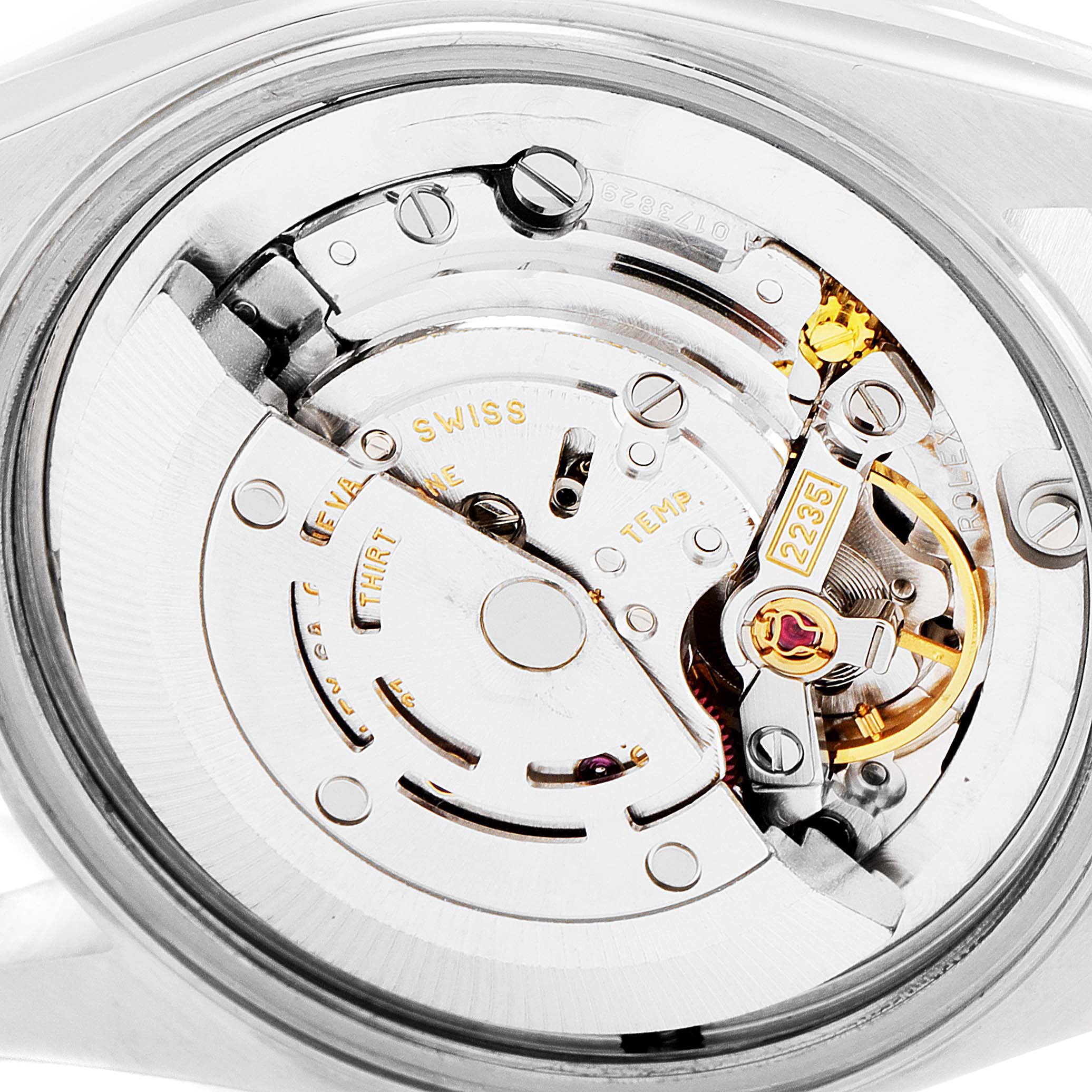 This image shows a close-up view of the movement mechanism of a Rolex Mid-Size 78273 Women
s Steel and Gold (two tone) Grey Dial 78273 Women
s Steel and Gold (two tone) Grey Dial watch, displaying intricate gears and components.