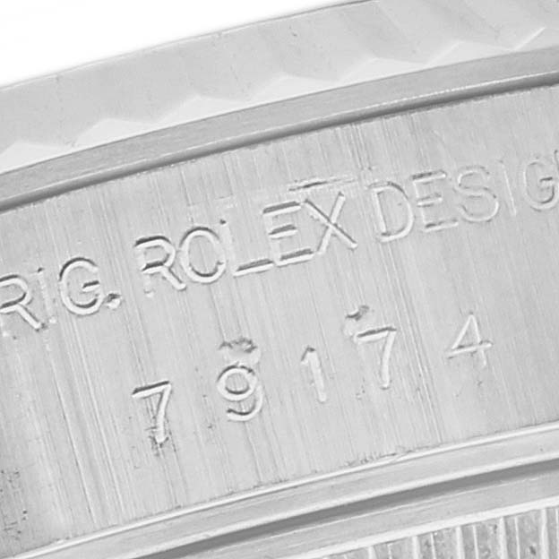 The image shows a close-up of the case back with the engraved serial number on a Rolex Datejust 79174 Women's Stainless Steel Pink Dial 79174 Women's Stainless Steel Pink Dial watch.