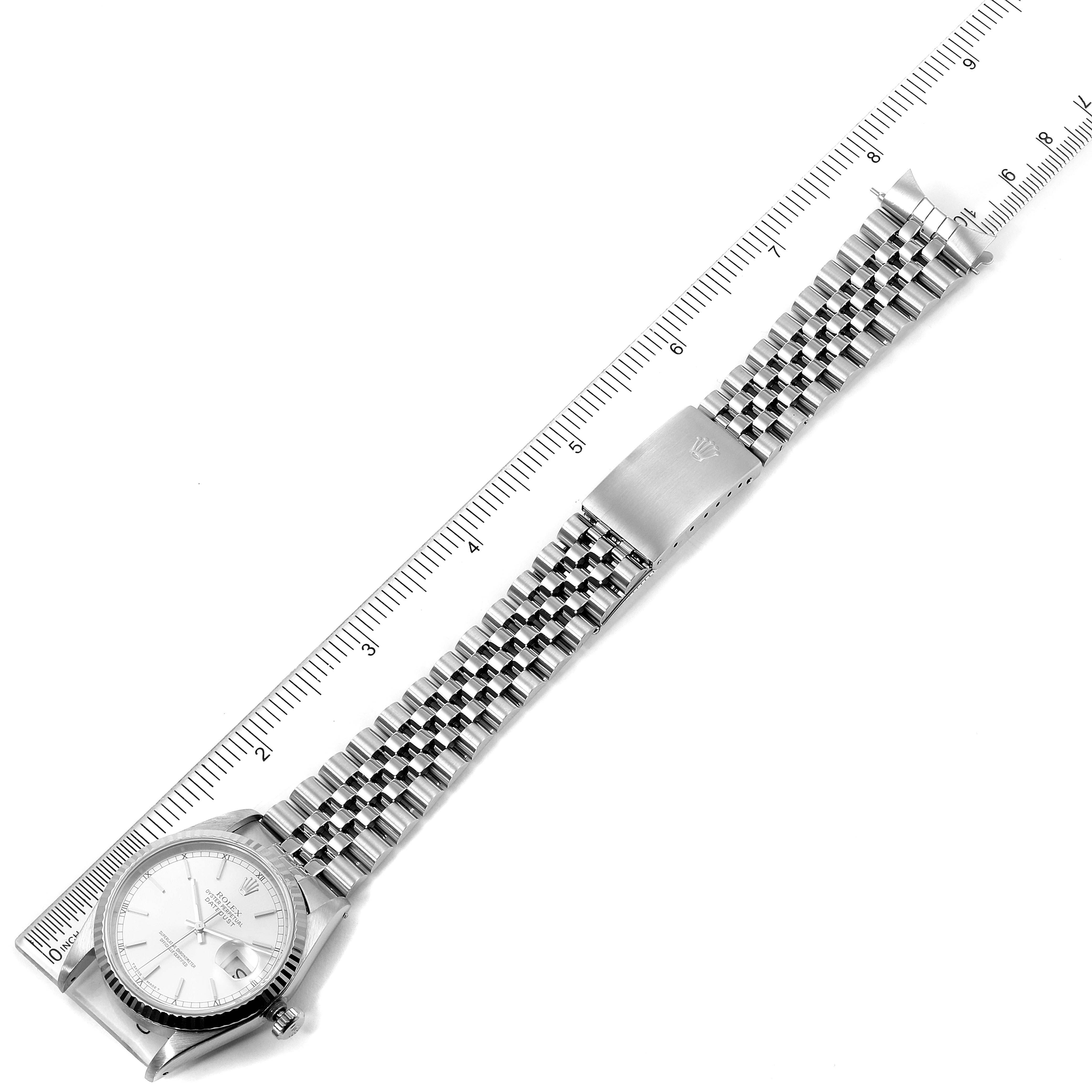 The image displays the Rolex Datejust 16234 Men's Stainless Steel Silver Dial 16234 Men's Stainless Steel Silver Dial watch from an overhead angle, showcasing the face, full bracelet, and clasp alongside a ruler for scale.