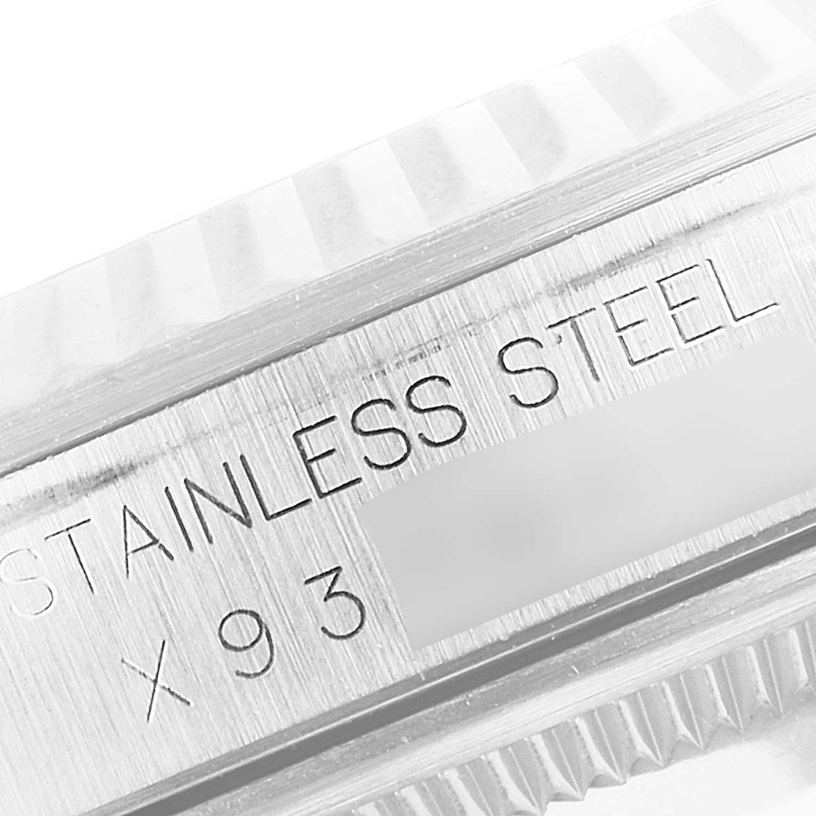 This close-up image shows the side of a Rolex Datejust 16234 Men's Stainless Steel Silver Dial 16234 Men's Stainless Steel Silver Dial watch, highlighting the stainless steel and part of the engraved serial number.