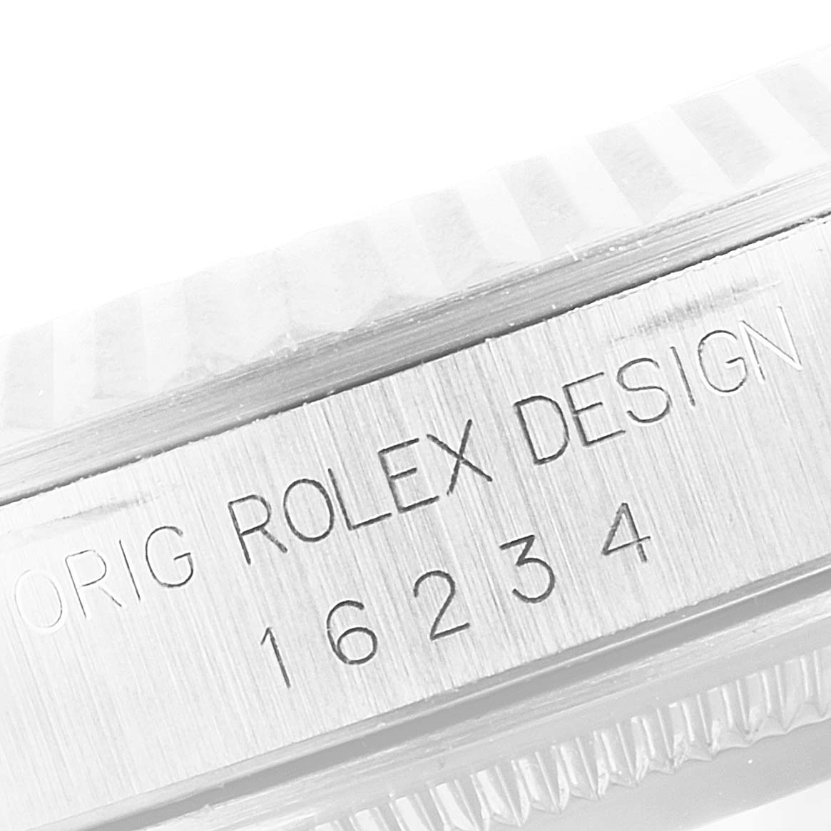The image shows a close-up of the side of a Rolex Datejust 16234 Men's Stainless Steel Silver Dial 16234 Men's Stainless Steel Silver Dial watch case, displaying the model number 16234 and "ROLEX DESIGN" engraving.