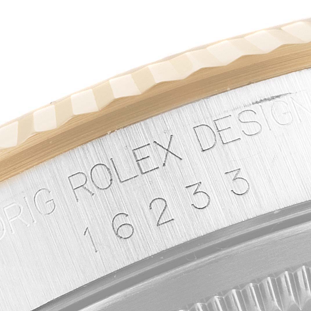 This image shows a close-up of the bezel and serial number on a Rolex Datejust 16233 Men's Steel and Gold (two tone) Black Dial 16233 Men's Steel and Gold (two tone) Black Dial 16233 model.