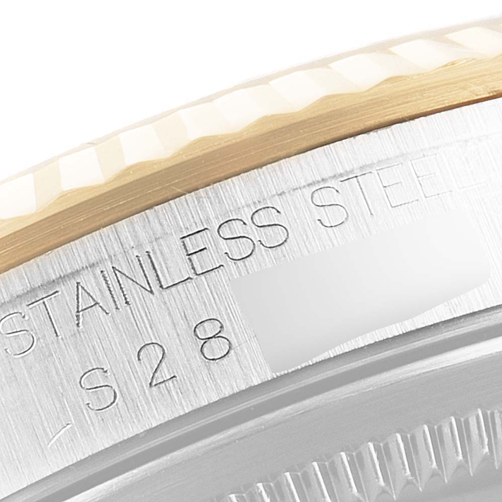 This image shows a close-up of the side of a Rolex Datejust 16233 Men's Steel and Gold (two tone) Black Dial 16233 Men's Steel and Gold (two tone) Black Dial watch case and bezel, highlighting the "STAINLESS STEEL" inscription.