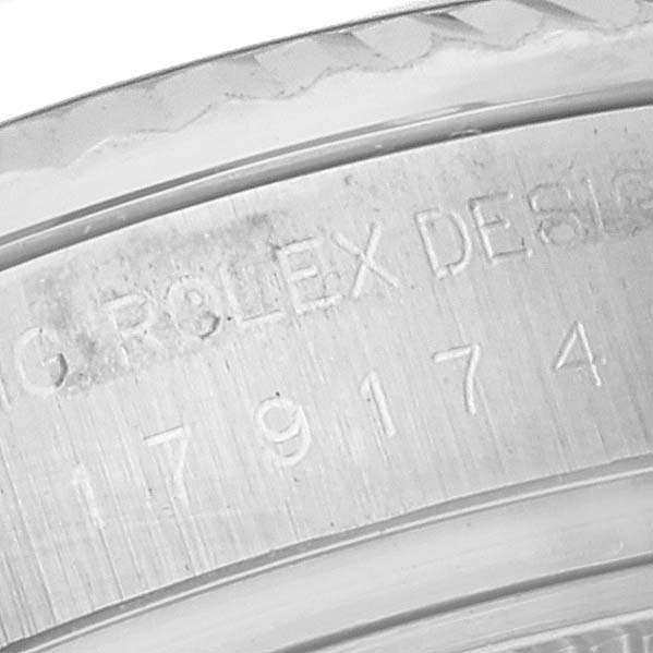 This image shows an angled close-up of the case and the engraved serial number on the inner bezel of a Rolex Datejust 179174 Women's Stainless Steel Silver Dial 179174 Women's Stainless Steel Silver Dial.