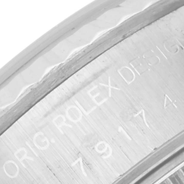 This image shows a close-up angle of the inner watch casing of a Rolex Datejust 79174 Women's Stainless Steel Silver Dial 79174 Women's Stainless Steel Silver Dial, displaying engraved text.