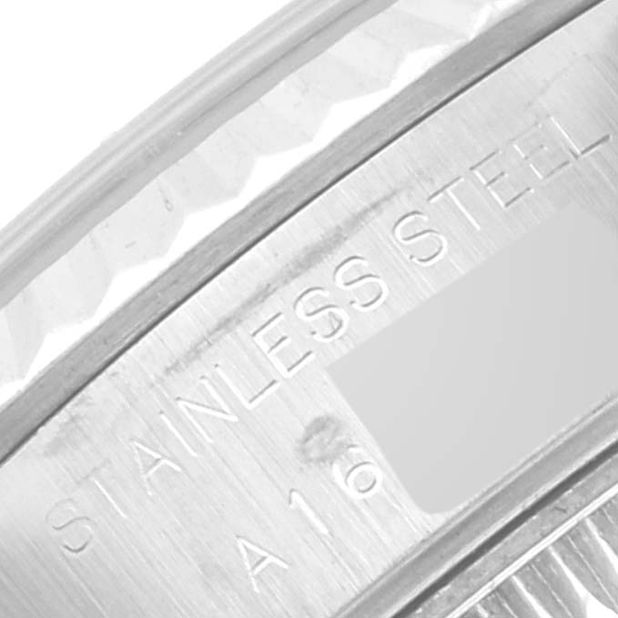 This close-up image shows the engraving on the stainless steel case of a Rolex Datejust 79174 Women's Stainless Steel Silver Dial 79174 Women's Stainless Steel Silver Dial watch.