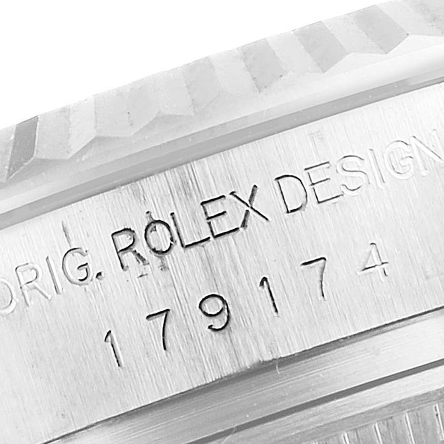 Close-up view of the engraving on the side of a Rolex Datejust 179174 Women's Stainless Steel Mother of Pearl Dial 179174 Women's Stainless Steel Mother of Pearl Dial watch case.