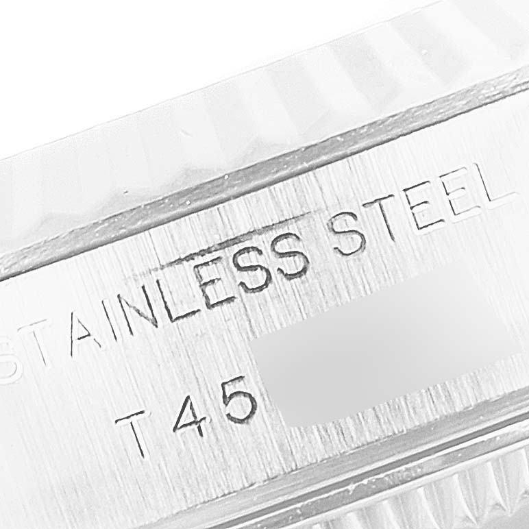 This image shows a close-up of the case back and part of the bezel of a Rolex Datejust 69174 Women
s Stainless Steel Silver Dial 69174 Women
s Stainless Steel Silver Dial, highlighting the "STAINLESS STEEL" engraving.