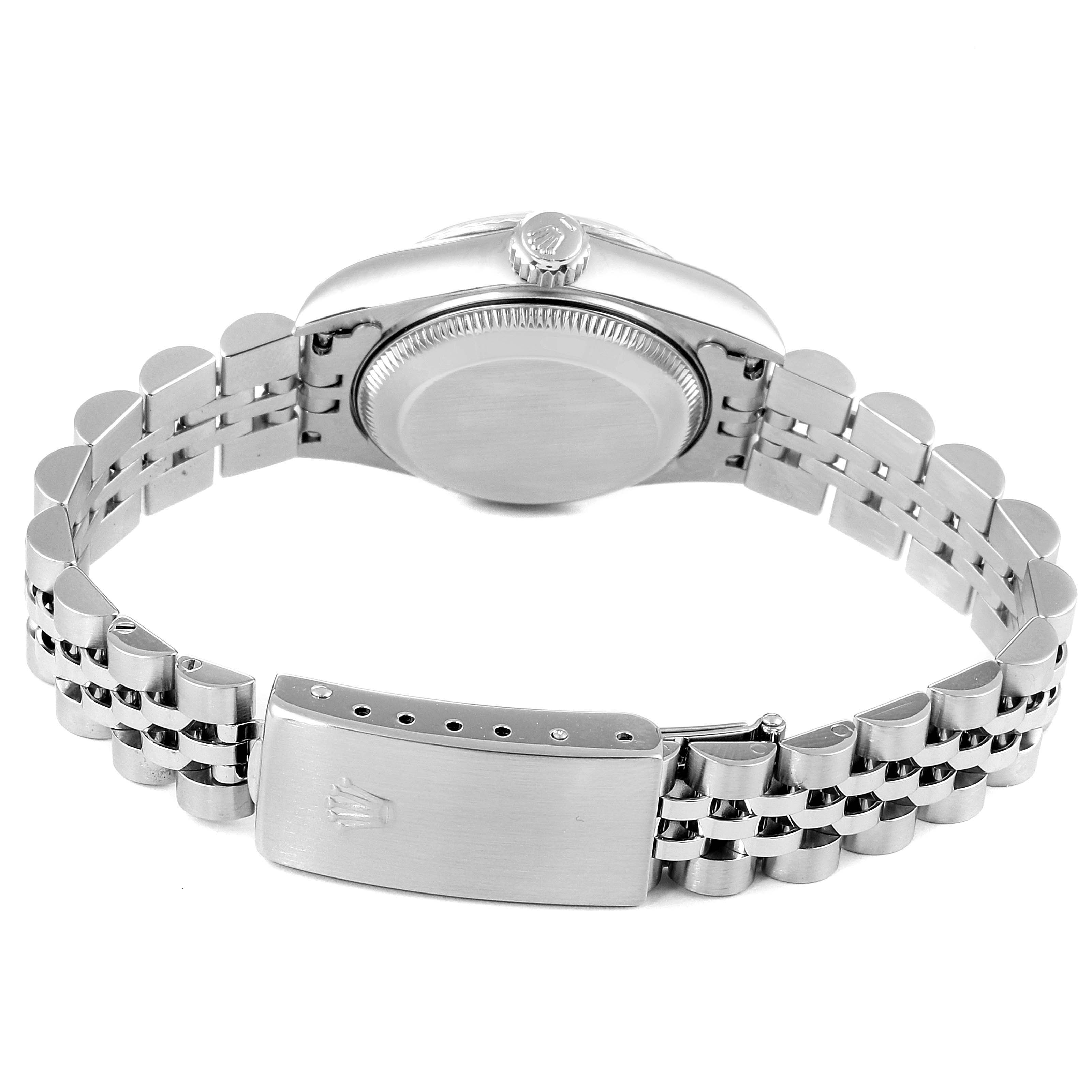 The image shows the back of a Rolex Datejust 69174 Women
s Stainless Steel Silver Dial 69174 Women
s Stainless Steel Silver Dial watch, focusing on the case back and the opened bracelet with the clasp.
