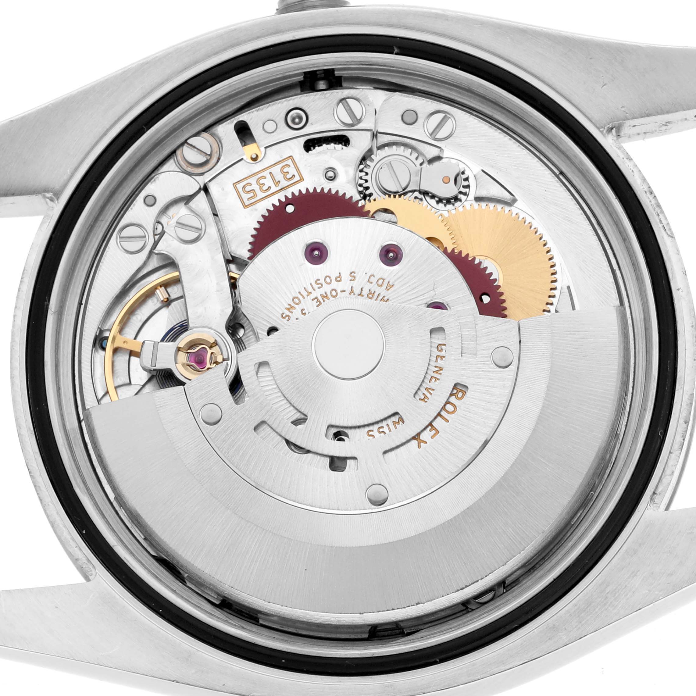 The image shows the movement of a Rolex Datejust 116234 Men's Stainless Steel Silver Dial watch from the back, highlighting gears and the rotor.