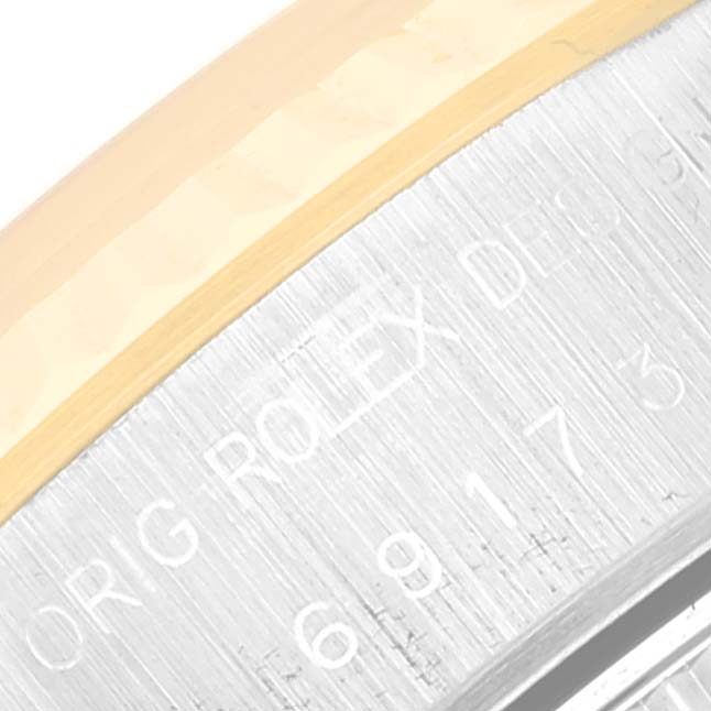 This image shows a close-up of the outer edge and engraved serial number of the Rolex Datejust 69173 Women's Steel and Gold (two tone) Champagne Dial 69173 Women's Steel and Gold (two tone) Champagne Dial watch case.