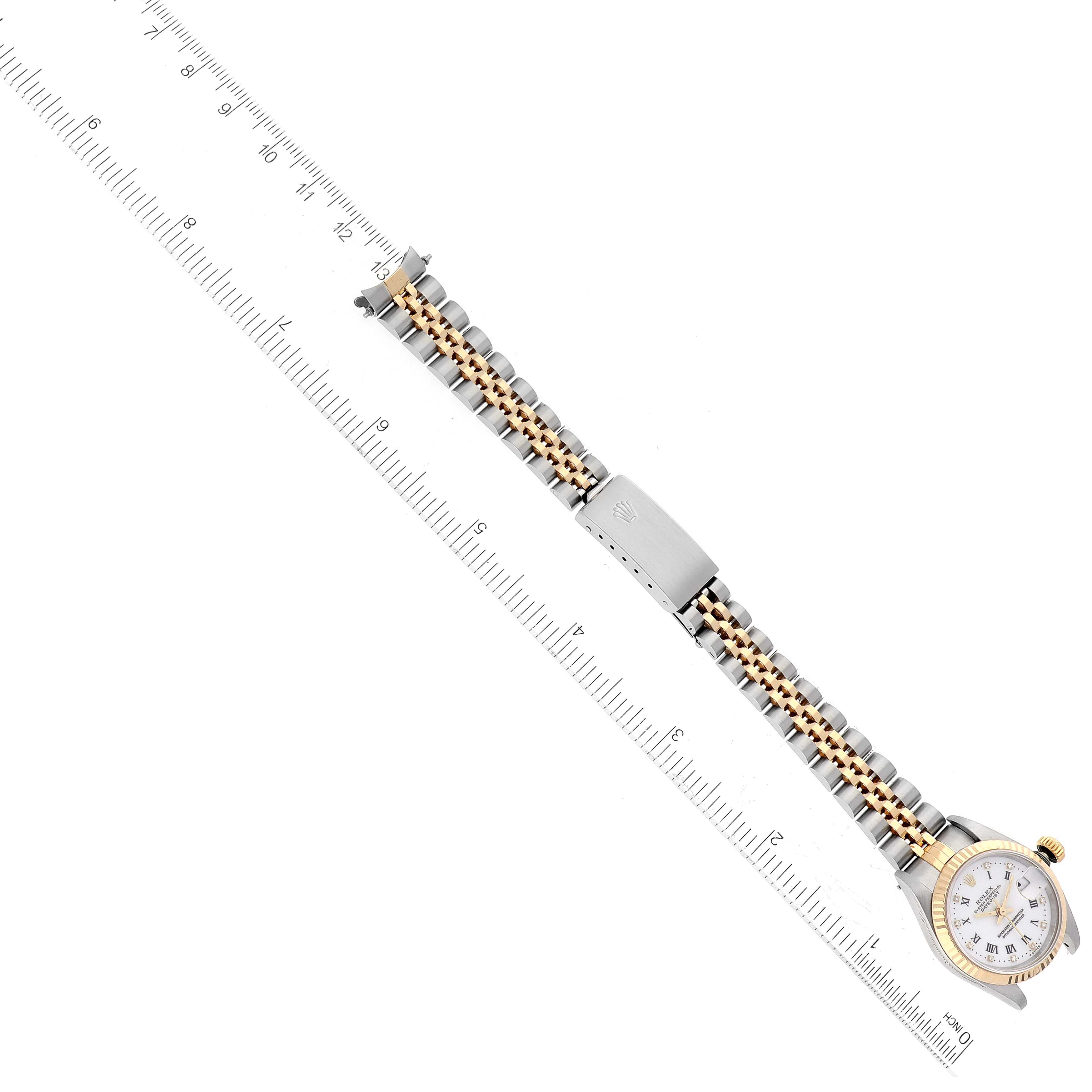 This image shows the Rolex Datejust 69173G Women's Steel and Gold (two tone) White Dial 69173G Women's Steel and Gold (two tone) White Dial watch laying flat with its face, bracelet, and clasp visible, measured against a ruler.