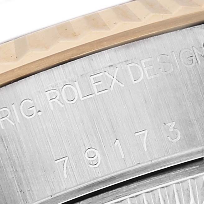 The image shows a close-up of the bezel and case side of a Rolex Datejust 79173 Women's Steel and Gold (two tone) Red Dial 79173 Women's Steel and Gold (two tone) Red Dial, including the engraved model number.