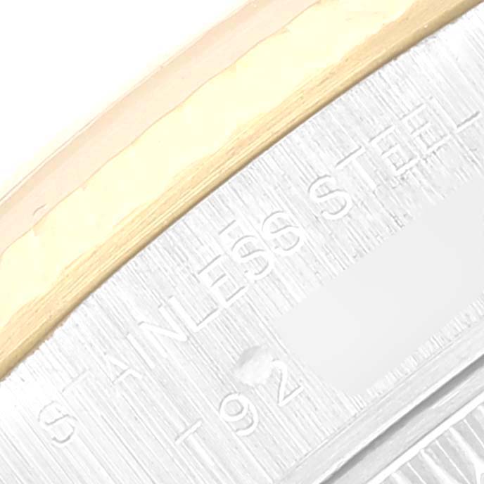 This is a close-up angle showing part of the metal bezel and case back of the Rolex Datejust 69173 Women's Steel and Gold (two tone) Mother of Pearl Dial 69173 Women's Steel and Gold (two tone) Mother of Pearl Dial watch, with "Stainless Steel" engraved.