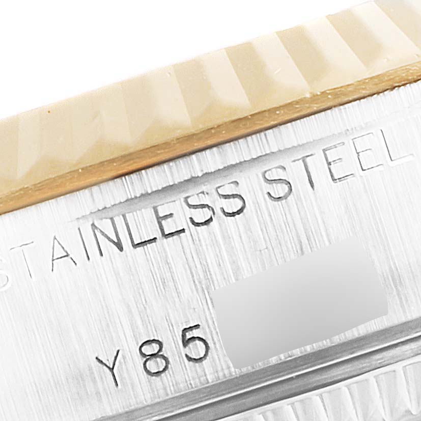 This close-up image shows the side of the Rolex Datejust 79173 Women
s Steel and Gold (two tone) Mother of Pearl Dial 79173 Women
s Steel and Gold (two tone) Mother of Pearl Dial watch, highlighting the bezel and part of the engraved stainless steel casing.