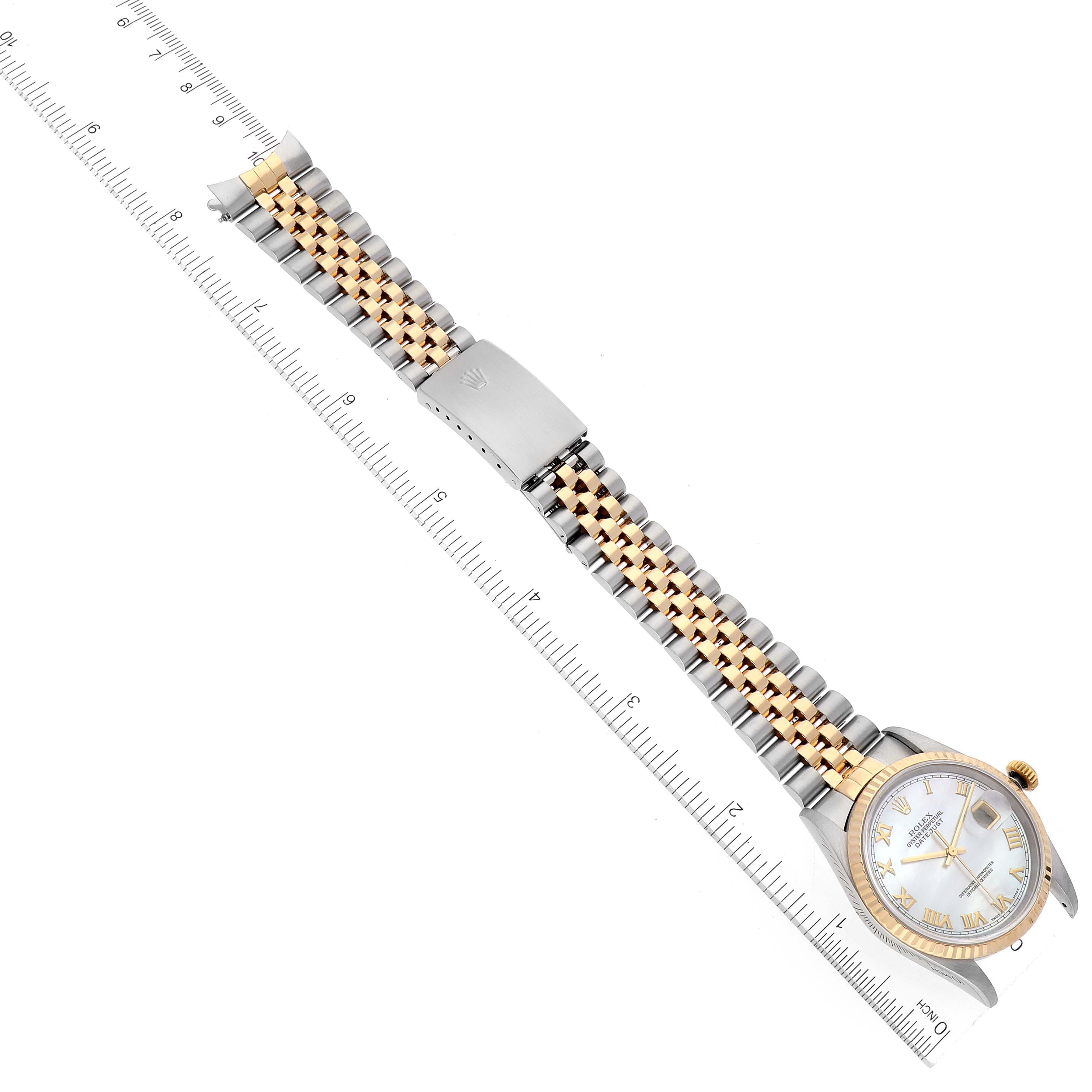 The image shows a Rolex Datejust 16233 Men's Steel and Gold (two tone) Mother of Pearl Dial 16233 Men's Steel and Gold (two tone) Mother of Pearl Dial watch laying flat, with a focus on the bracelet and clasp, placed along a measuring ruler.
