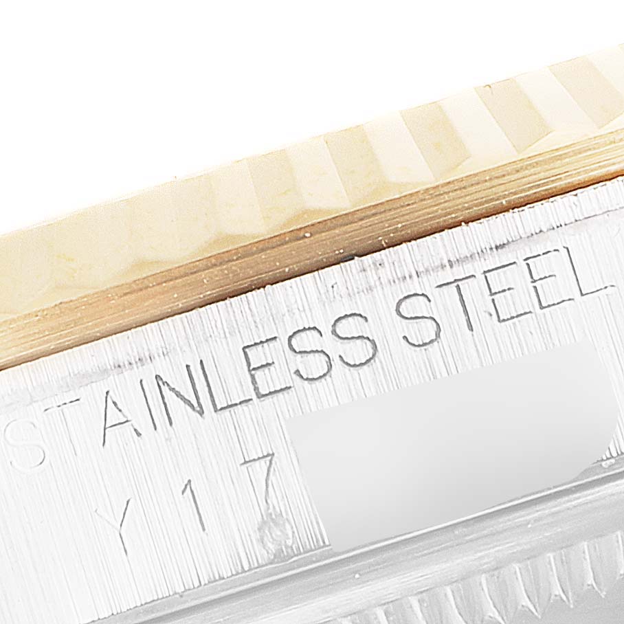 This close-up image shows the fluted bezel and the stainless steel inscription on the case of a Rolex Datejust 16233 Men
s Steel and Gold (two tone) Grey Dial 16233 Men
s Steel and Gold (two tone) Grey Dial watch.