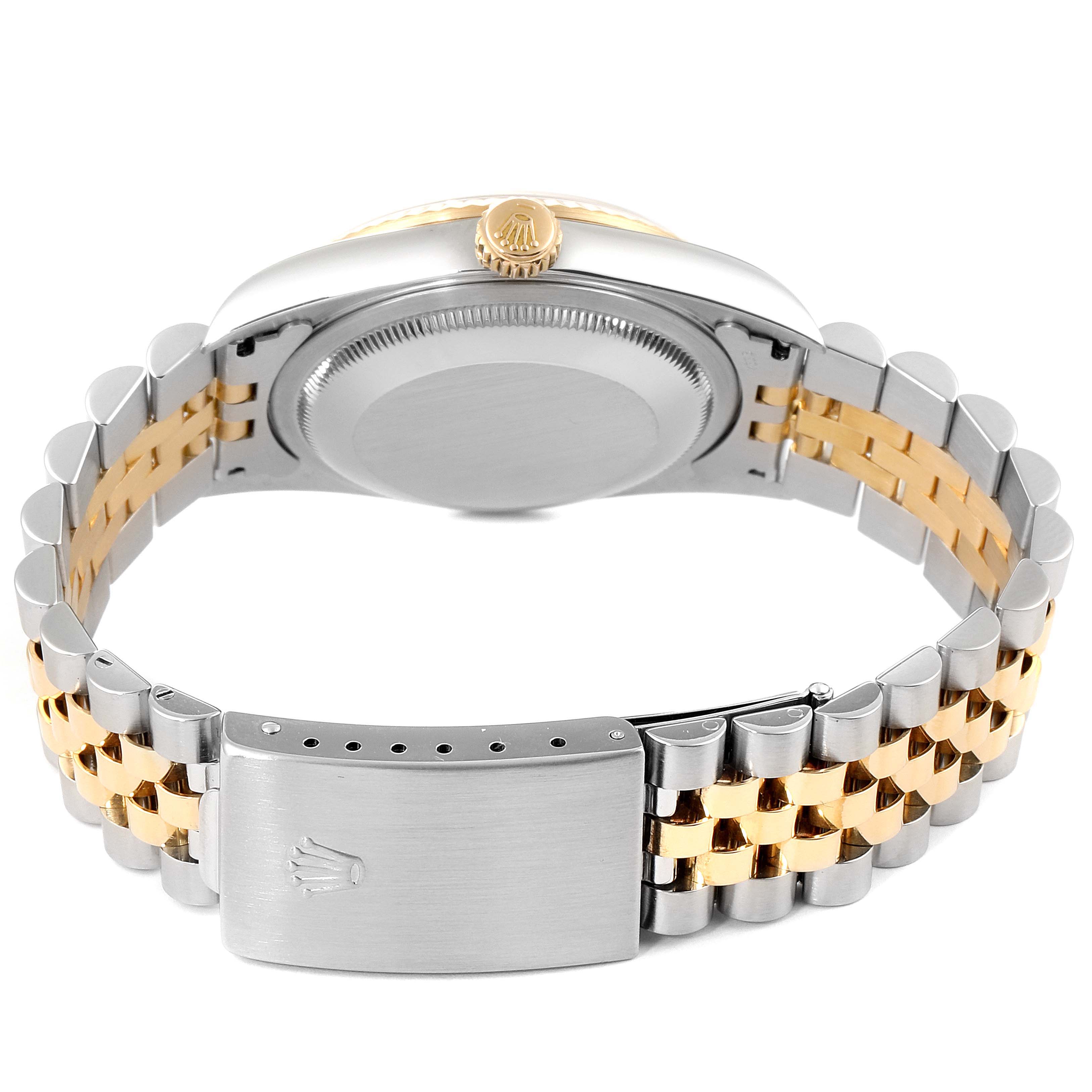 The image shows the back view of a Rolex Datejust 16233 Men
s Steel and Gold (two tone) Grey Dial 16233 Men
s Steel and Gold (two tone) Grey Dial watch, highlighting its clasp, bracelet, and case back.