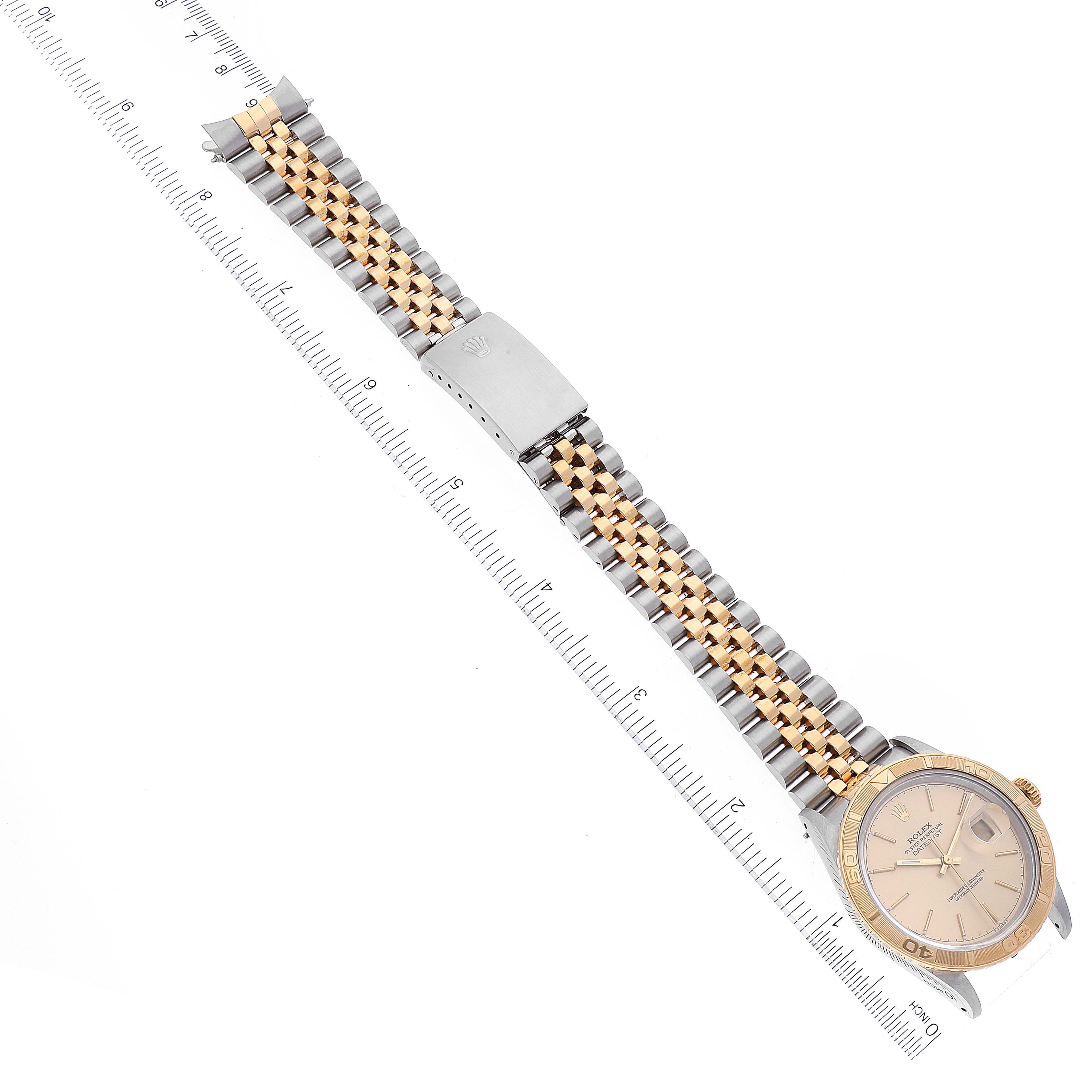 The image shows a Rolex Turn-o-Graph 16263 Men's Steel and Gold (two tone) Champagne Dial 16263 Men's Steel and Gold (two tone) Champagne Dial watch from a top-down angle, displaying the dial, bezel, bracelet, and clasp laying next to a ruler for scale.