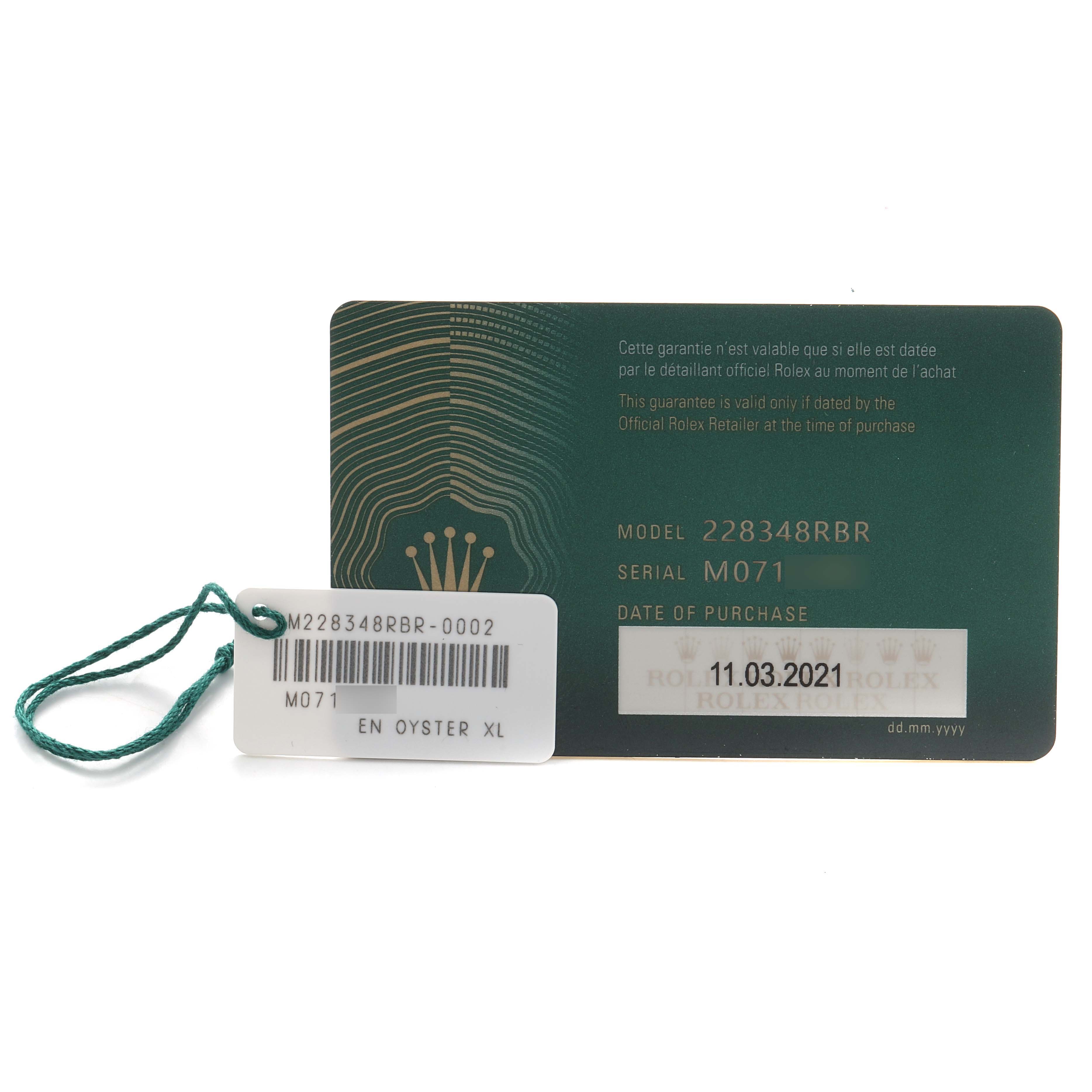 The image shows a Rolex President 228348 Men's Yellow Gold Champagne Dial model guarantee card and a tag with model and serial numbers displayed.