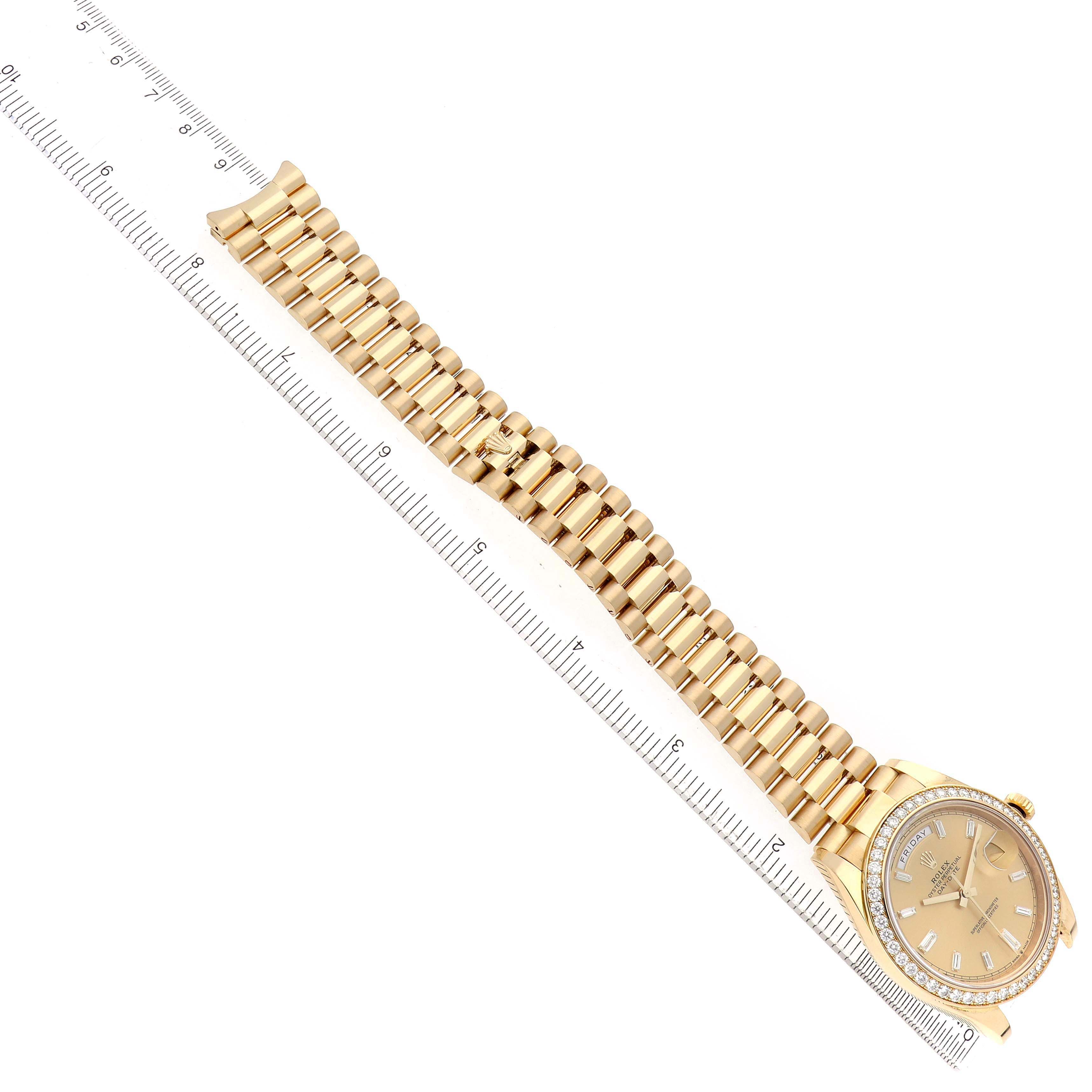 The image shows a top-down view of a Rolex President 228348 Men's Yellow Gold Champagne Dial watch, highlighting the bracelet and bezel with a ruler for scale.
