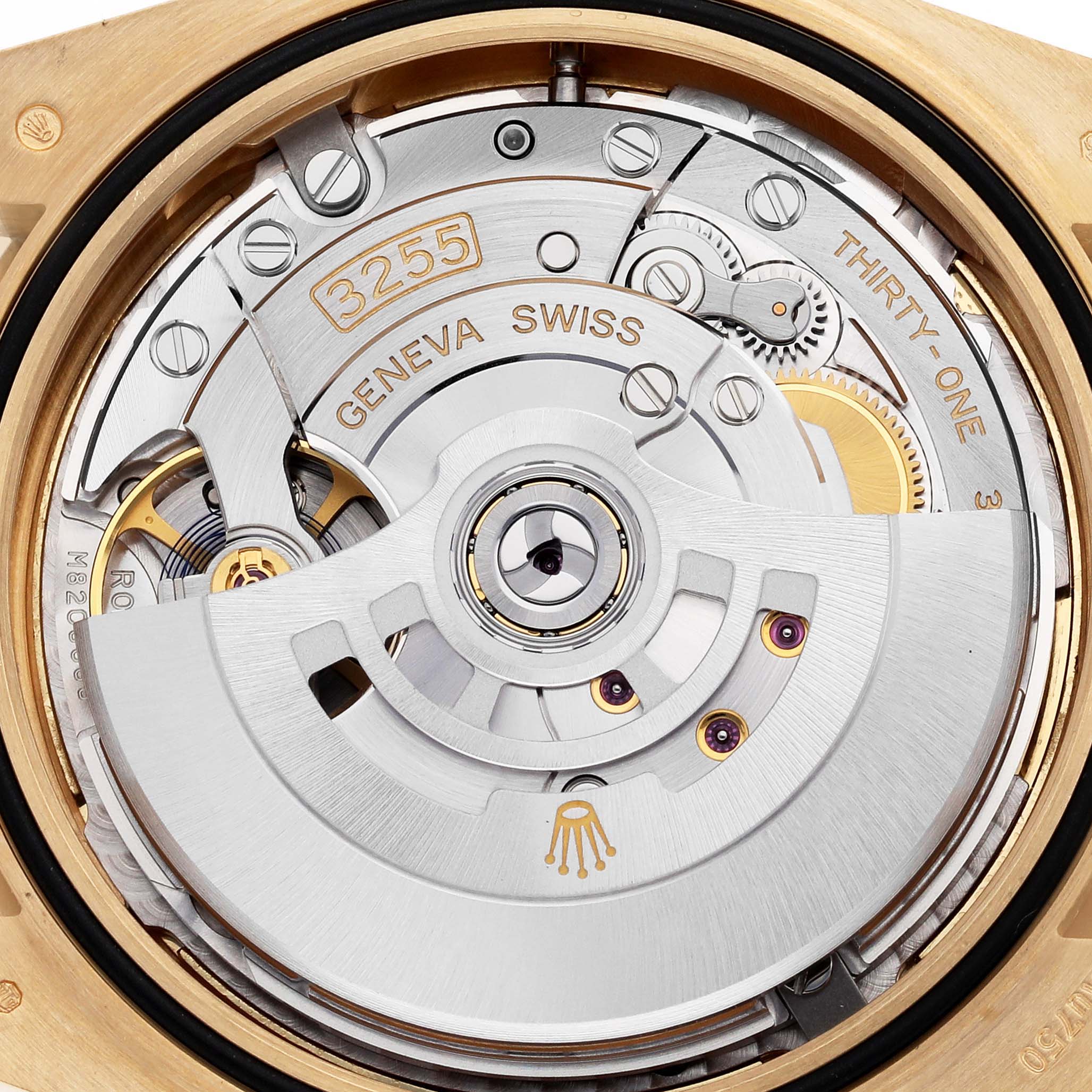 The image shows the movement of a Rolex President 228348 Men's Yellow Gold Champagne Dial model watch from a top view, highlighting the rotor and intricate mechanics.