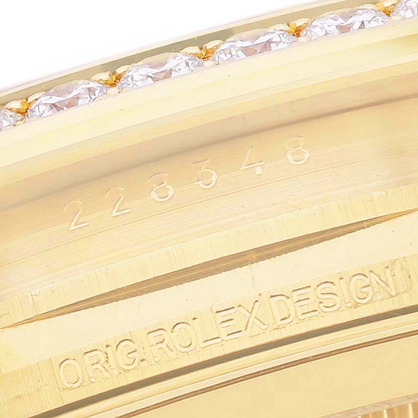The image shows a close-up of the Rolex President 228348 Men's Yellow Gold Champagne Dial model bezel with diamond detailing and engraved serial numbers.