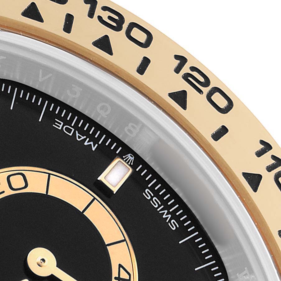 The image shows a close-up of the bezel, part of the dial, and hands of a Rolex Daytona 126503 Men's Steel and Gold (two tone) Black Dial watch.