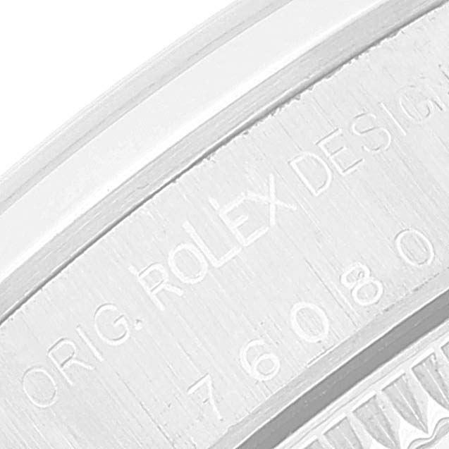 This image shows a close-up of the side case with engraved text on the Rolex Oyster Perpetual 76080 Women's Stainless Steel Blue Dial 76080 Women's Stainless Steel Blue Dial watch.