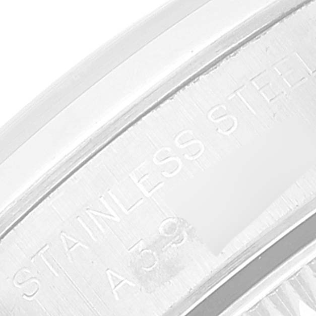 The image shows a close-up of the stainless steel part of a Rolex Oyster Perpetual 76080 Women's Stainless Steel Black Dial 76080 Women's Stainless Steel Black Dial watch, specifically the inner bezel or case back.