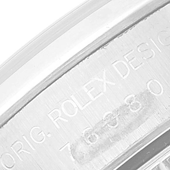 This is a close-up view of the engravings on the side of the casing for a Rolex Oyster Perpetual 76080 Women's Stainless Steel Black Dial 76080 Women's Stainless Steel Black Dial watch.