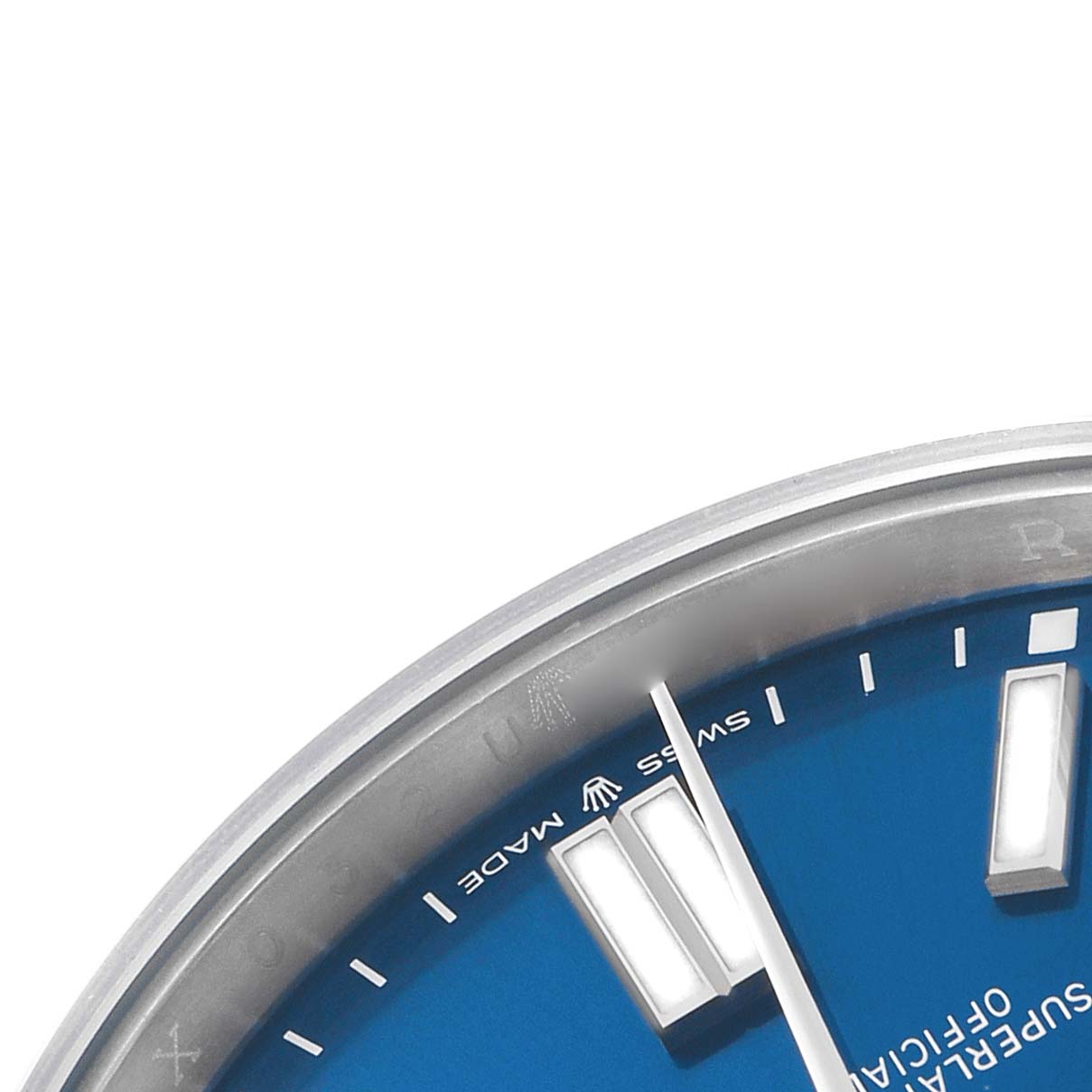The image shows a close-up of the dial edge and hands of a Rolex Oyster Perpetual 124300 Men's Stainless Steel Blue Dial watch, highlighting the blue color and Swiss Made text.