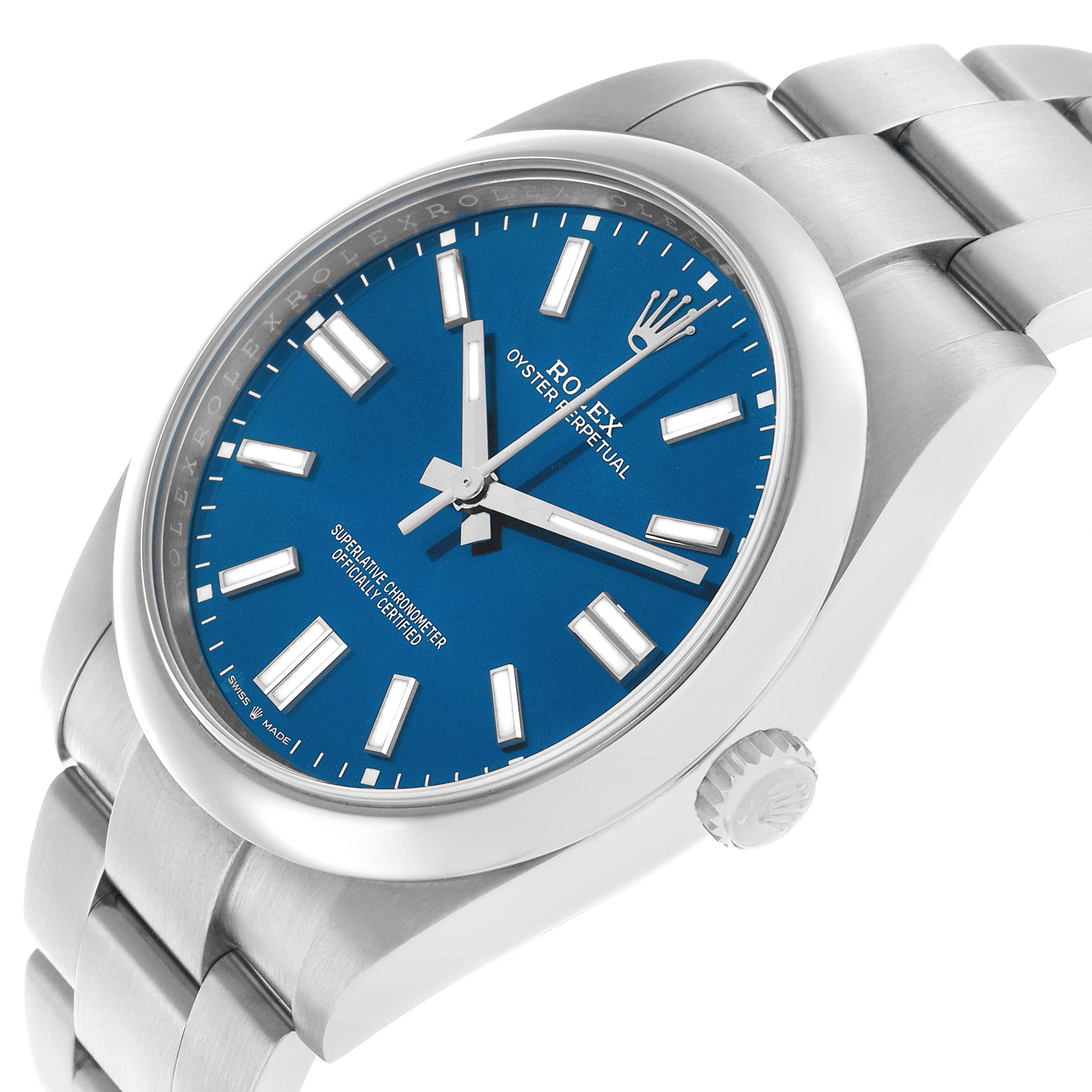 The Rolex Oyster Perpetual 124300 Men's Stainless Steel Blue Dial watch is shown at an angle highlighting the blue dial, index markers, crown, and part of the bracelet.