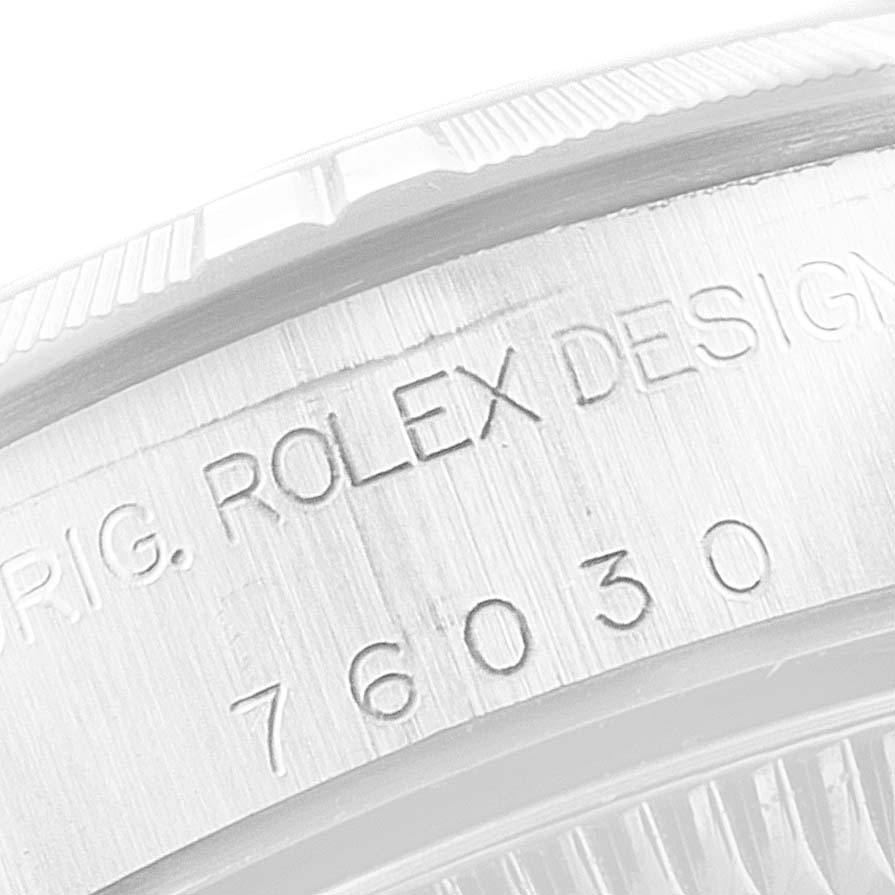 This image shows a close-up of the case back edge of a Rolex Oyster Perpetual 76030 Women
s Stainless Steel Blue Dial 76030 Women
s Stainless Steel Blue Dial watch, highlighting the engraved text and model number.
