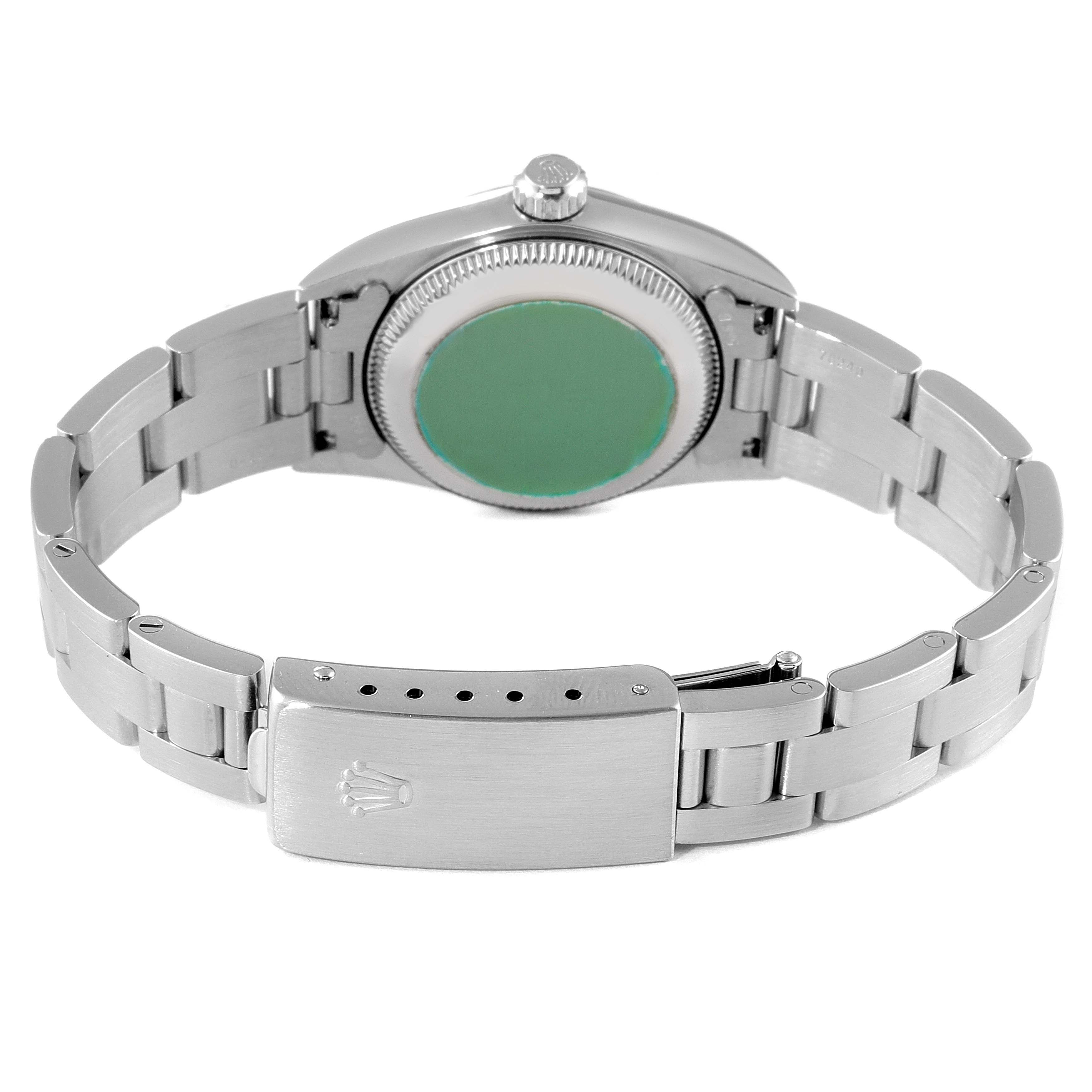 The image shows the back and clasp of the Rolex Oyster Perpetual 76030 Women
s Stainless Steel Blue Dial 76030 Women
s Stainless Steel Blue Dial watch, highlighting its bracelet and green case back.