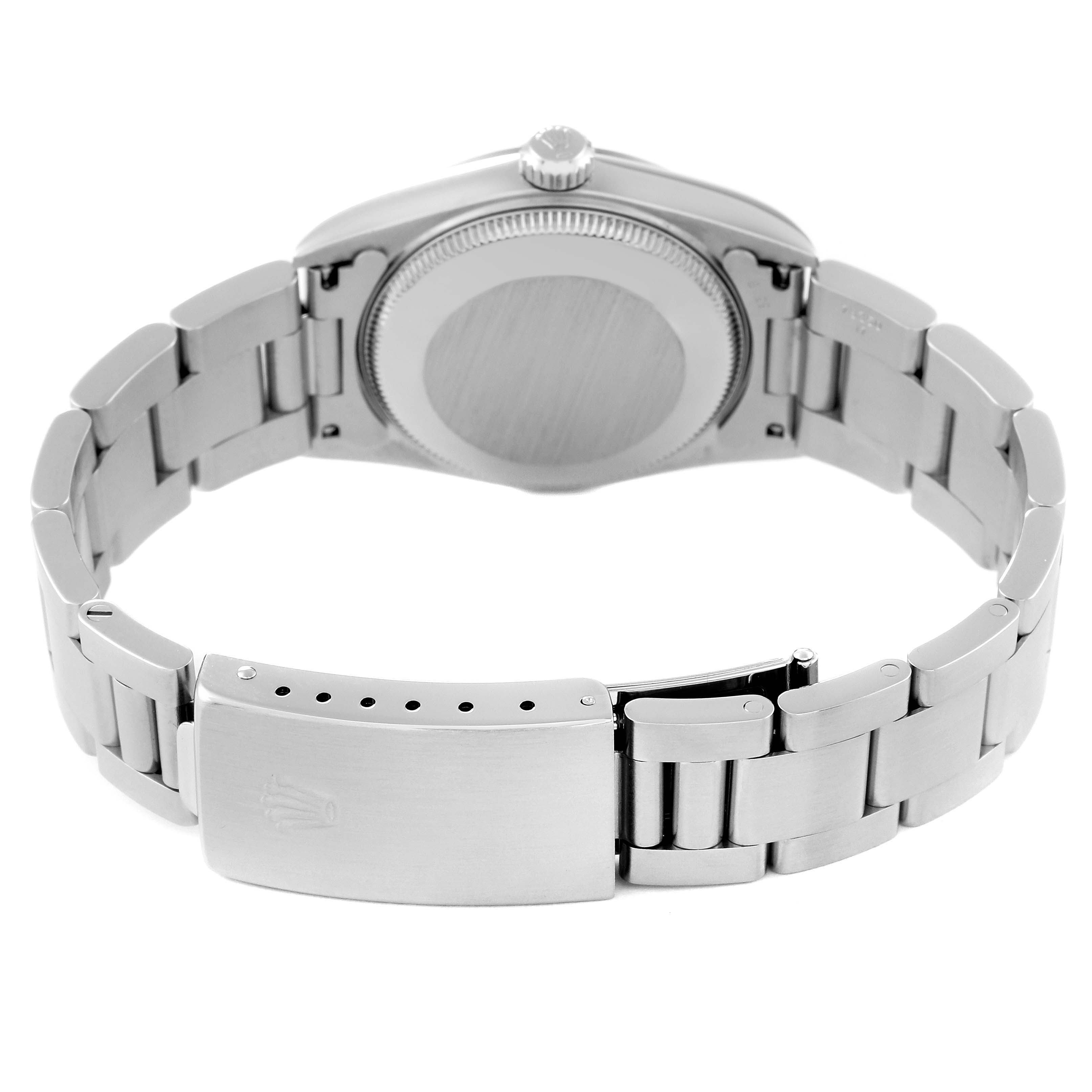 The image shows the back case and bracelet of a Rolex Mid-Size 77080 Women
s Stainless Steel Blue Dial 77080 Women
s Stainless Steel Blue Dial watch from a rear angle, highlighting the clasp and links.