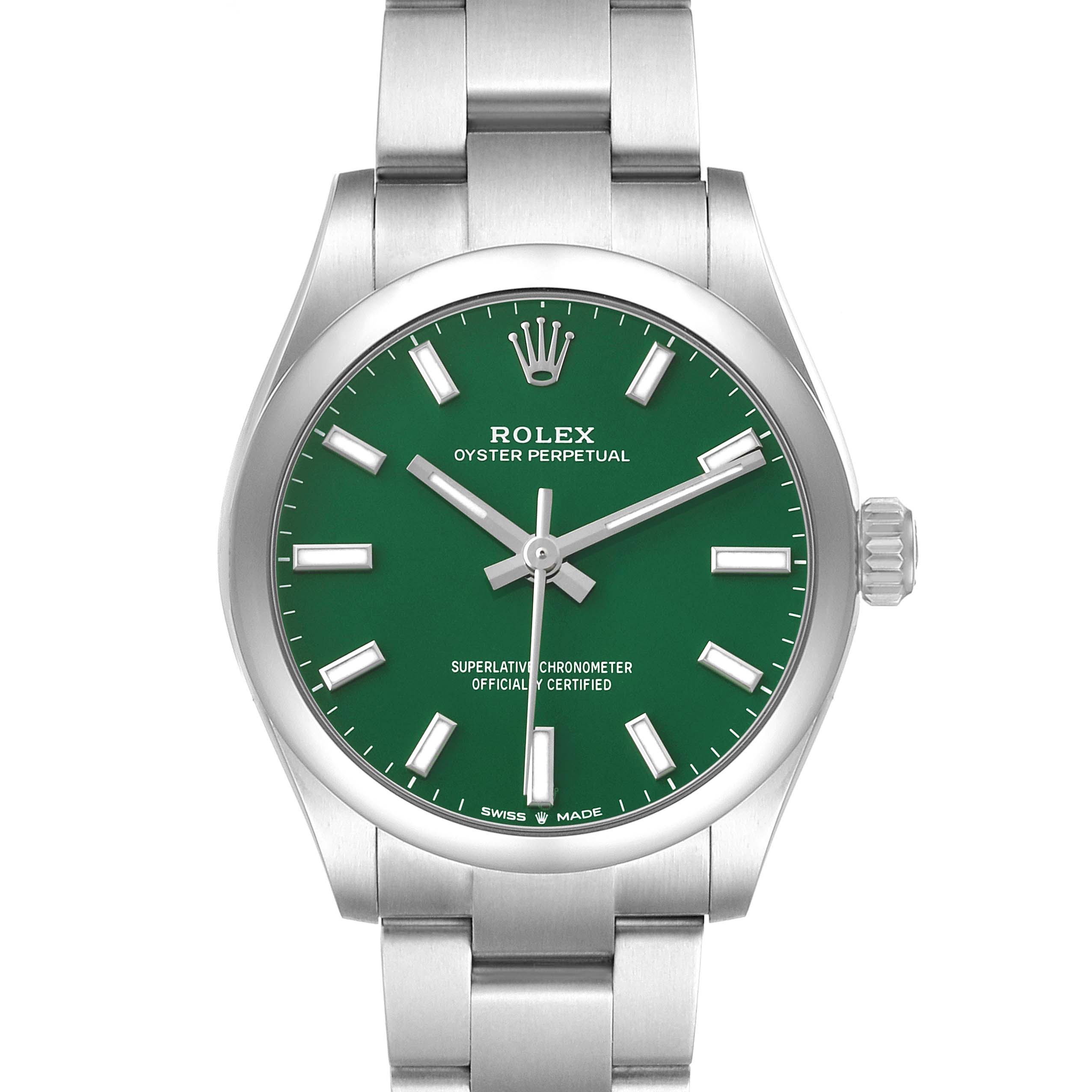 The Rolex Oyster Perpetual mid-size watch is shown from a top-down angle, highlighting its green dial, silver hands, and bracelet.