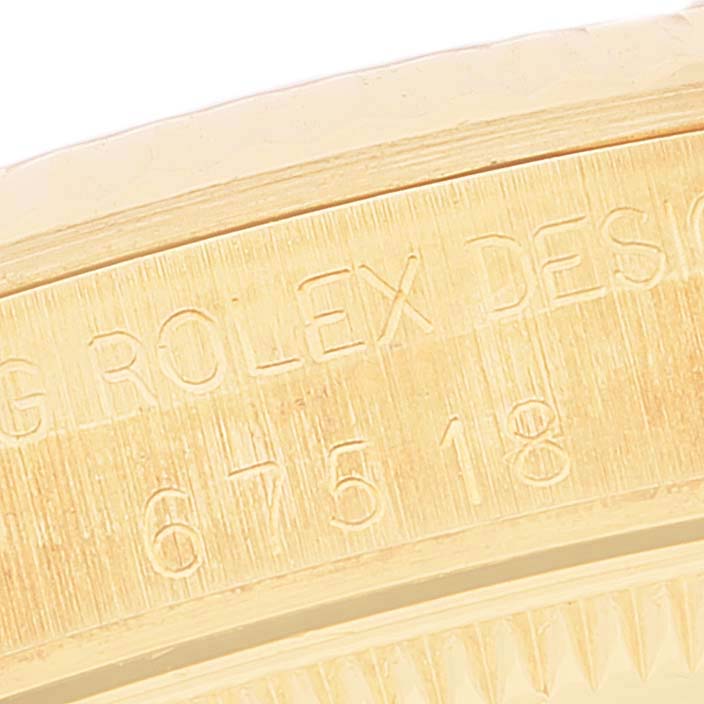 The image shows an angled close-up of the case side, showing the model and serial number of the Rolex President 67518 Women
s Yellow Gold White Dial 67518 Women
s Yellow Gold White Dial watch.