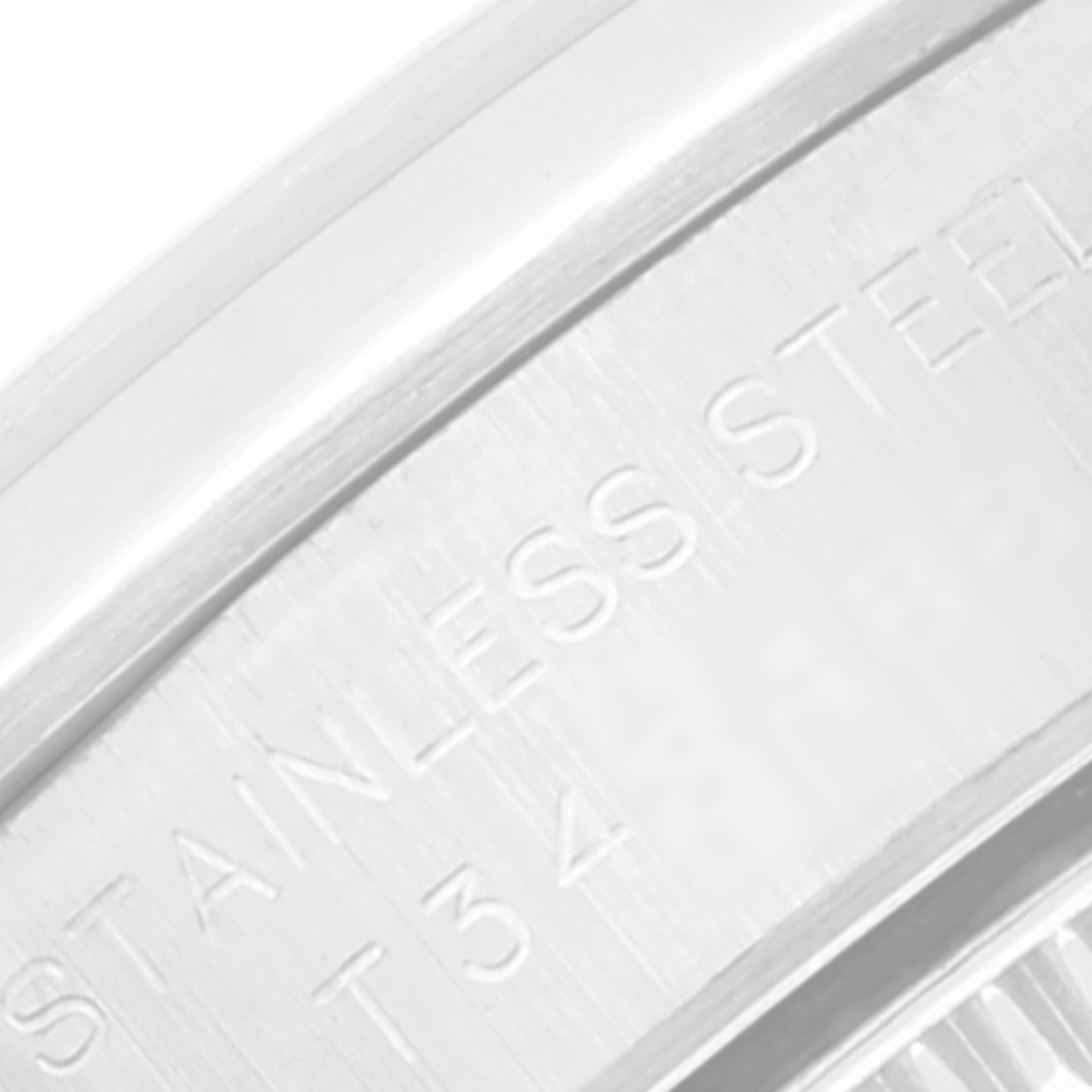 This close-up image shows the side engraving on the stainless steel case of a Rolex Oyster Perpetual 67180 Women's Stainless Steel Pink Dial 67180 Women's Stainless Steel Pink Dial watch.