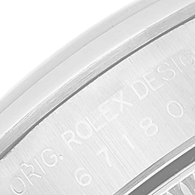 This close-up image shows the engraved case back of the Rolex Oyster Perpetual 67180 Women's Stainless Steel Pink Dial 67180 Women's Stainless Steel Pink Dial watch.