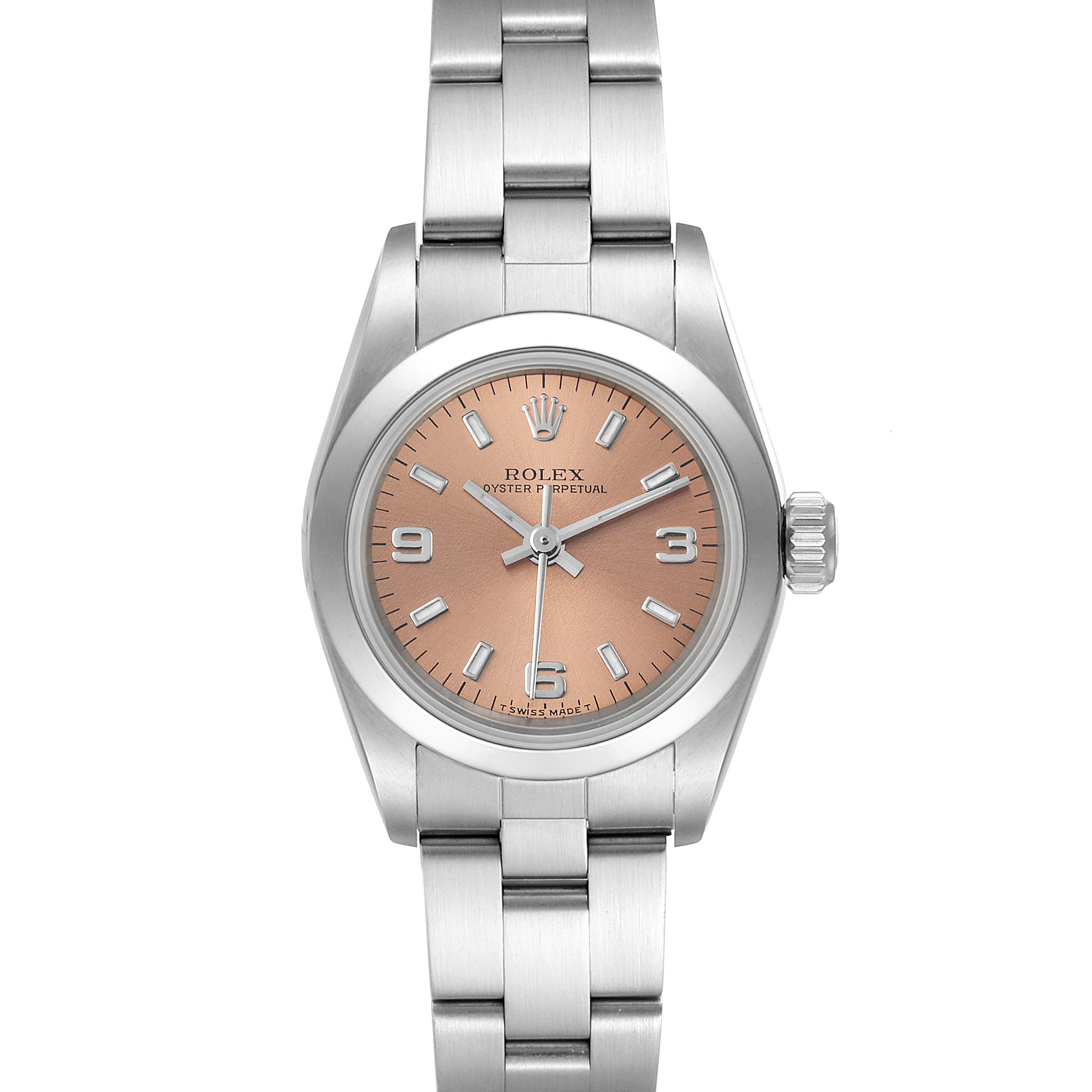 The image shows a front view of a Rolex Oyster Perpetual 67180 Women
s Stainless Steel Pink Dial 67180 Women
s Stainless Steel Pink Dial watch with a silver band and a pink dial.