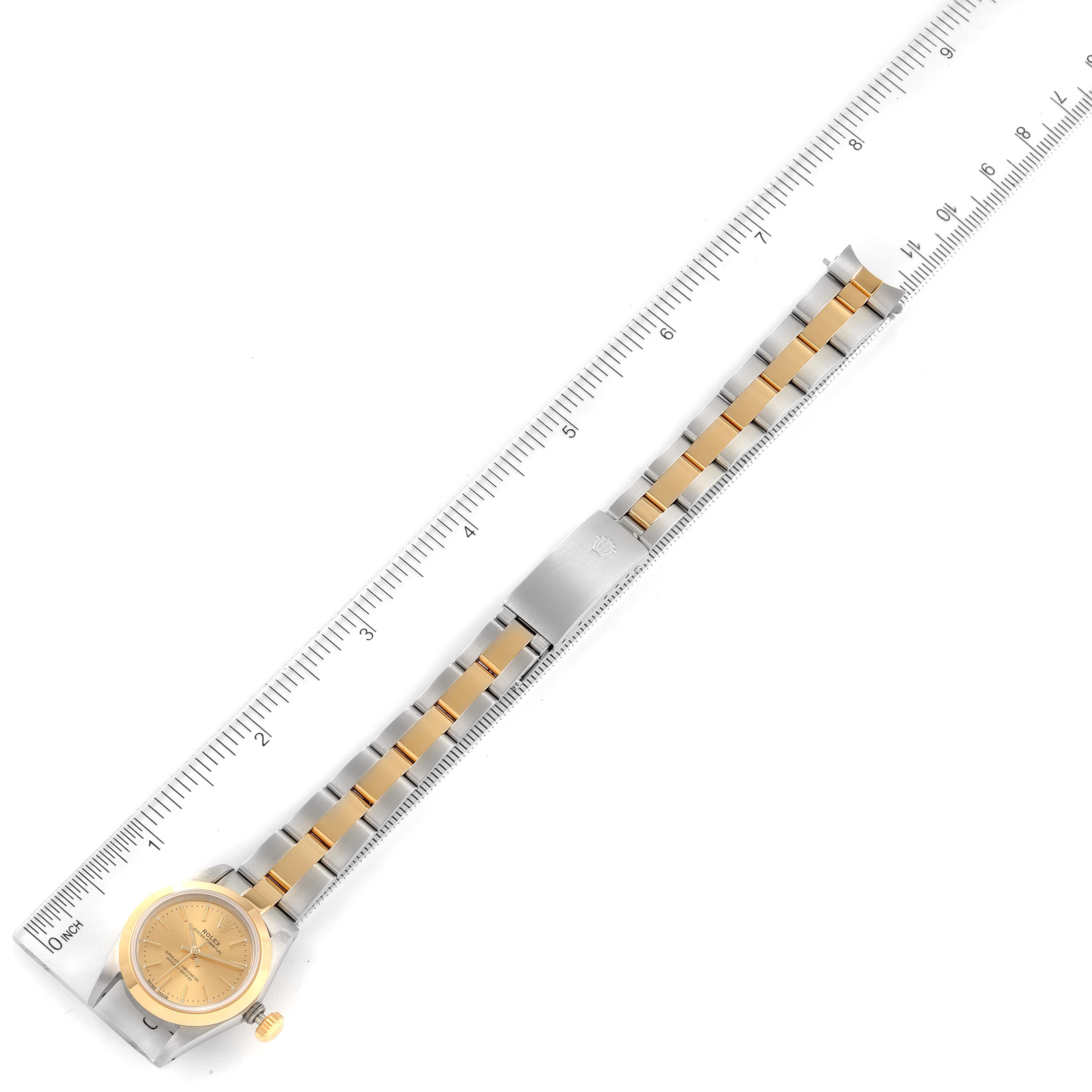 The image shows a top-down view of a Rolex Oyster Perpetual 67183 Women
s Steel and Gold (two tone) Champagne Dial 67183 Women
s Steel and Gold (two tone) Champagne Dial watch, including the face, bracelet, and clasp, measured with a ruler.