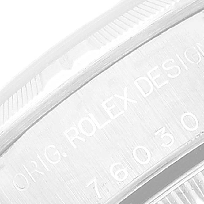 This image shows a close-up angle of the engraved text and edge detailing on the back of a Rolex Oyster Perpetual 76030 Women's Stainless Steel Pink Dial 76030 Women's Stainless Steel Pink Dial watch.