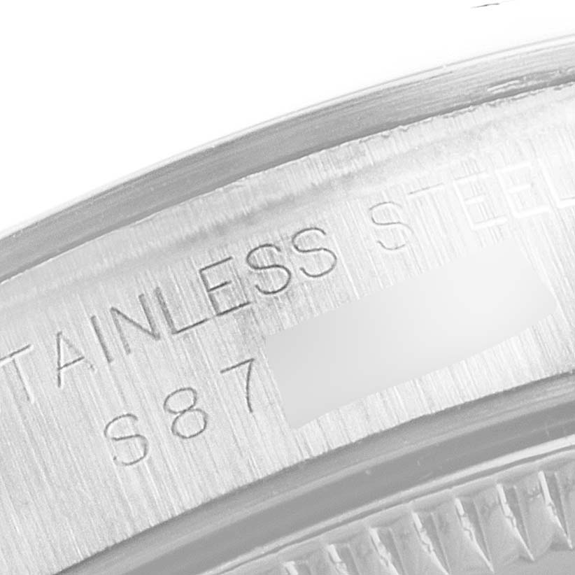 The image shows a close-up of the stainless steel casing and engravings on the Oyster Perpetual model by Rolex.